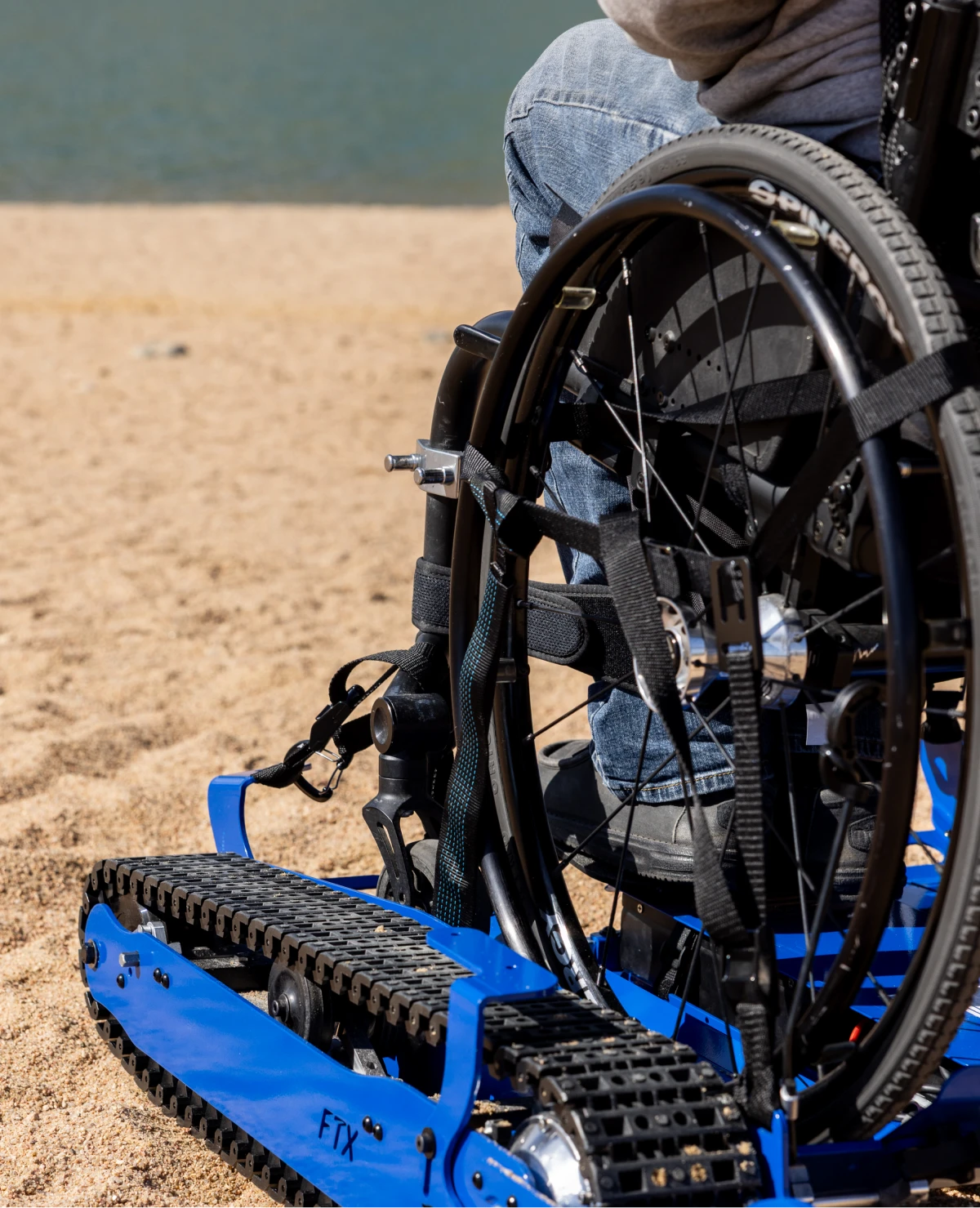 Person in wheelchair navigating beach terrain