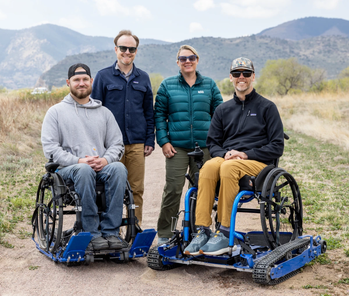 Friends in wheelchairs on a trail