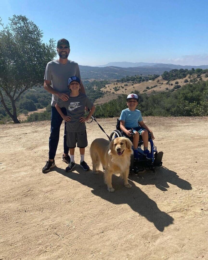 Family hiking with golden retriever outdoors