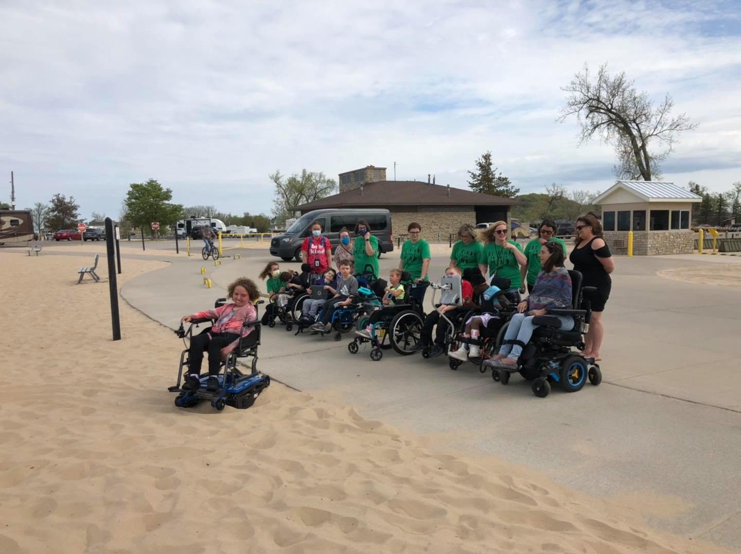 Group of people with wheelchairs on beach